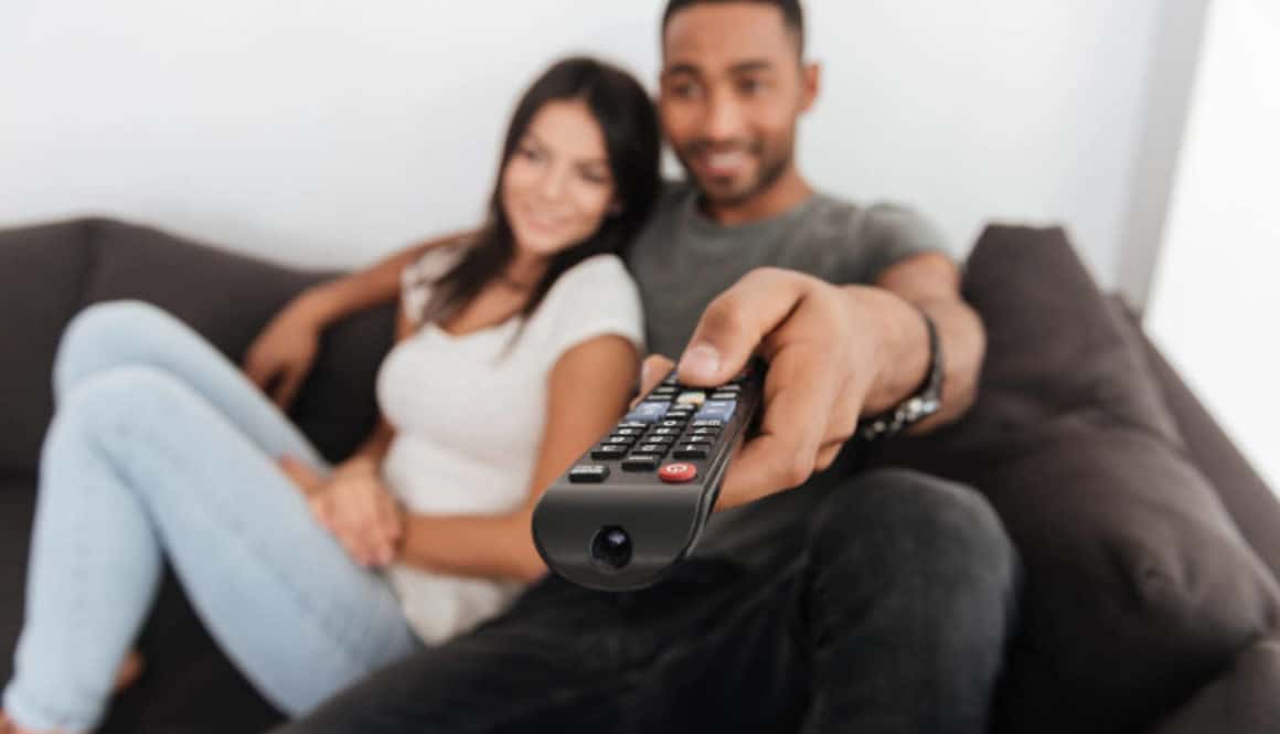 iptv subscription happy young couple hugging and watching tv