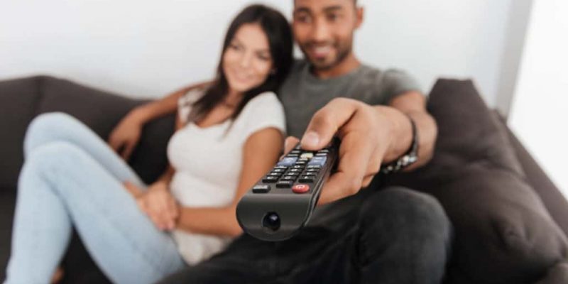 iptv subscription happy young couple hugging and watching tv