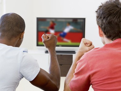 best IPTV service two men in living room watching television best IPTV service two men in living room watching television